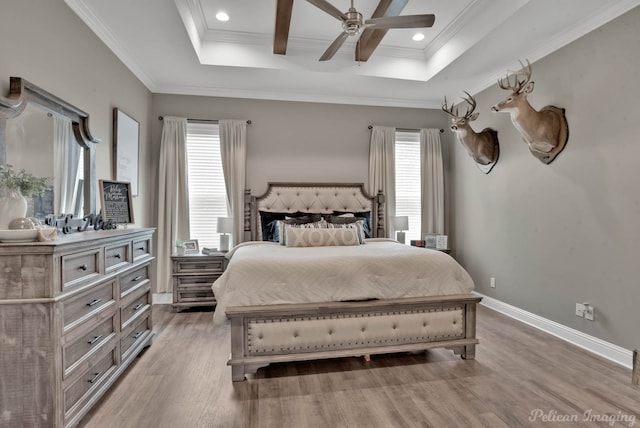 bedroom with hardwood / wood-style floors, beamed ceiling, ornamental molding, coffered ceiling, and ceiling fan