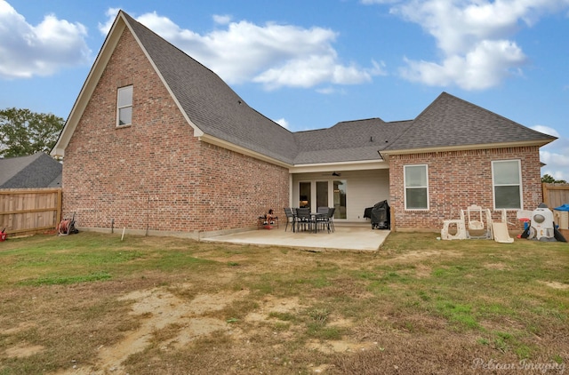 rear view of house with a lawn, a patio, and ceiling fan