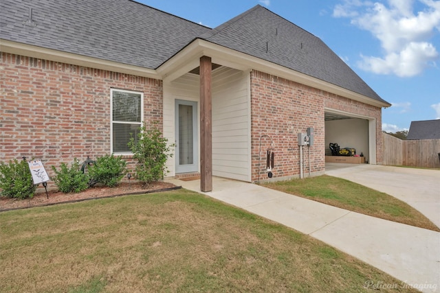 entrance to property with a garage and a yard