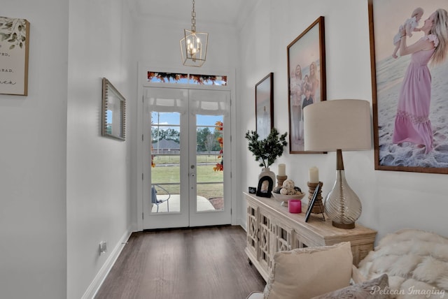 entryway with dark wood-type flooring, an inviting chandelier, and french doors