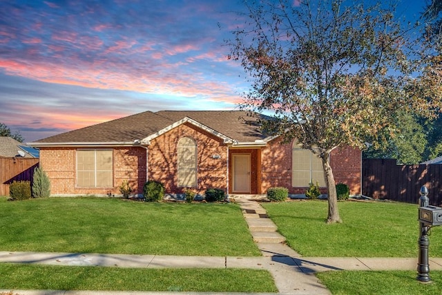 ranch-style home with a lawn