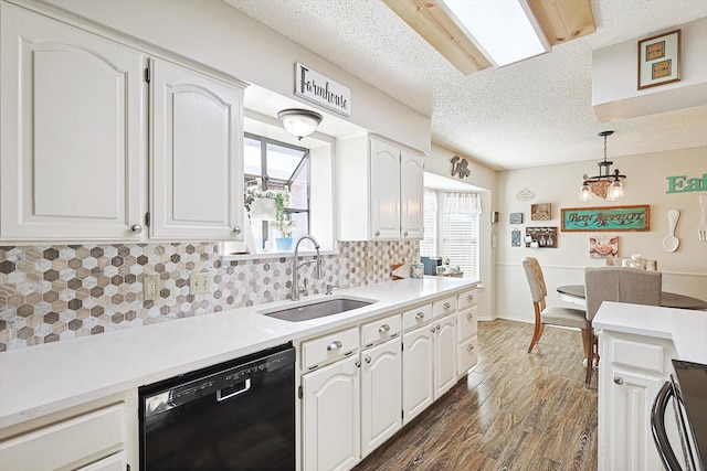 kitchen featuring white cabinets, black dishwasher, and sink