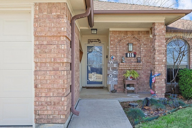 view of exterior entry featuring a garage