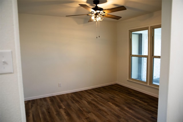 spare room featuring ceiling fan and dark wood-type flooring