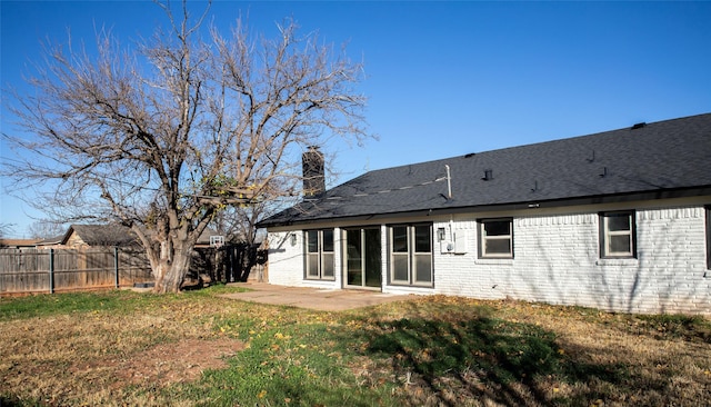 back of property featuring a yard and a patio