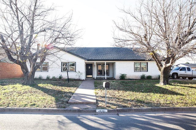 ranch-style home featuring a front yard