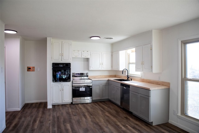 kitchen featuring gray cabinetry, stainless steel appliances, sink, white cabinets, and dark hardwood / wood-style floors