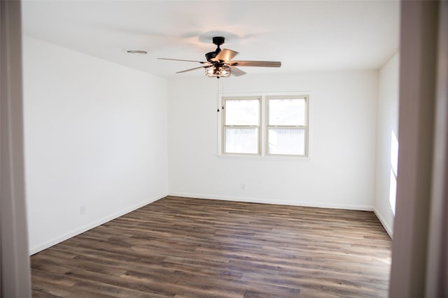 spare room with dark hardwood / wood-style floors and ceiling fan