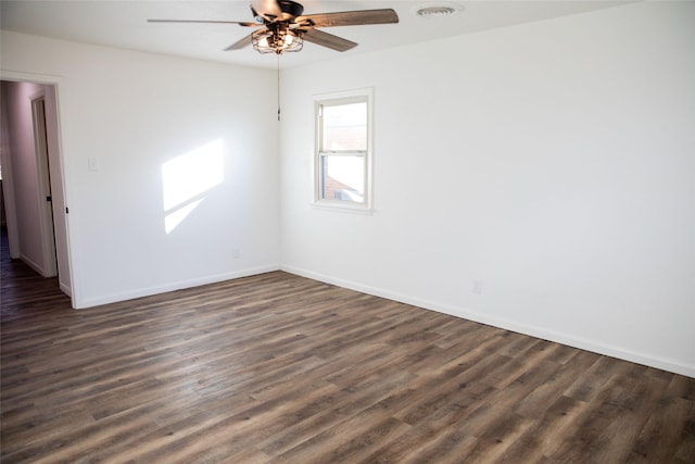 spare room featuring ceiling fan and dark hardwood / wood-style flooring