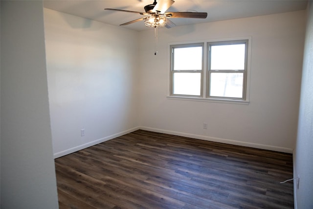 spare room featuring ceiling fan and dark wood-type flooring