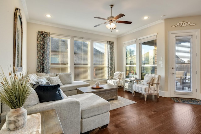 living room with ornamental molding, dark hardwood / wood-style floors, and ceiling fan