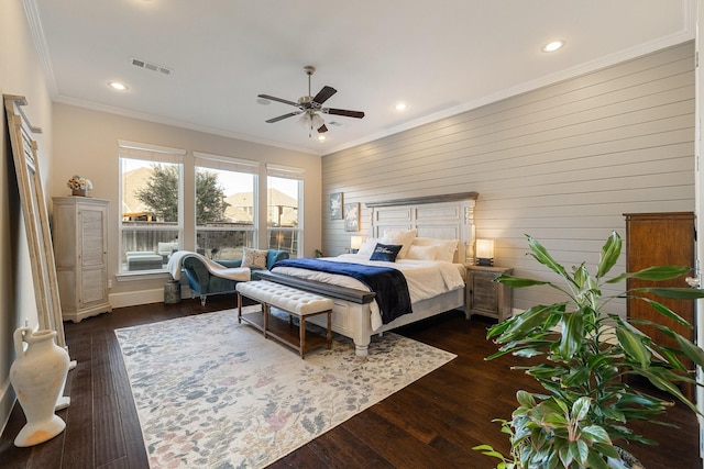 bedroom with crown molding, ceiling fan, and dark hardwood / wood-style flooring