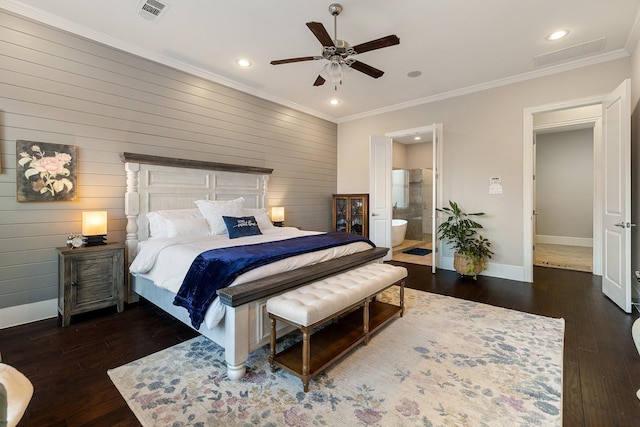 bedroom featuring crown molding, dark wood-type flooring, ensuite bath, and ceiling fan