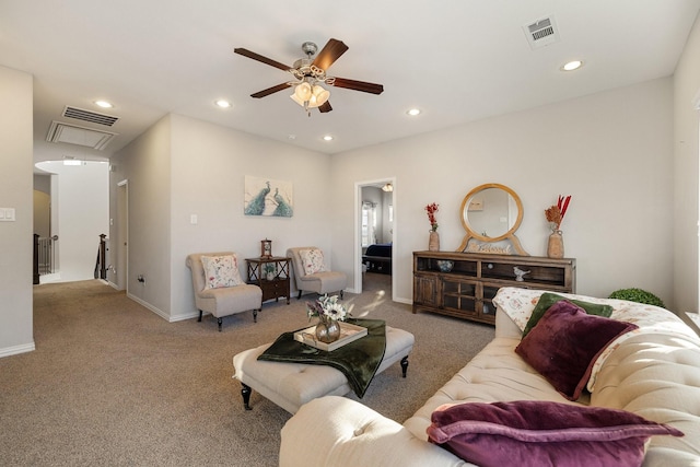 living room with ceiling fan and carpet