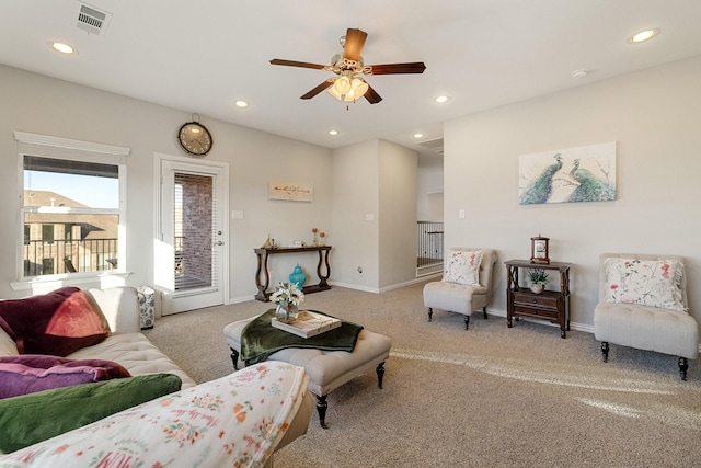 living room with light colored carpet and ceiling fan