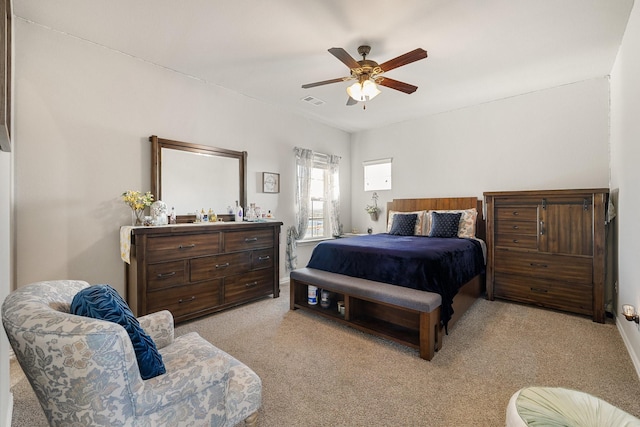 bedroom with ceiling fan and light carpet