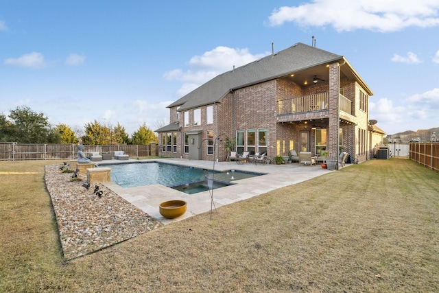 view of swimming pool featuring central AC, ceiling fan, a patio, and a lawn