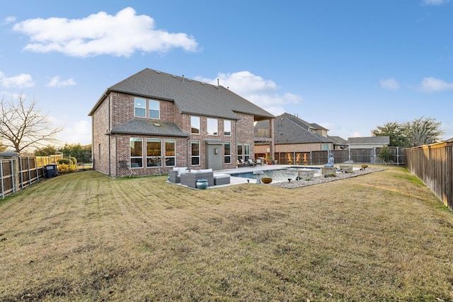 rear view of property featuring a fenced in pool, an outdoor hangout area, and a lawn