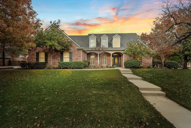 cape cod home with a yard