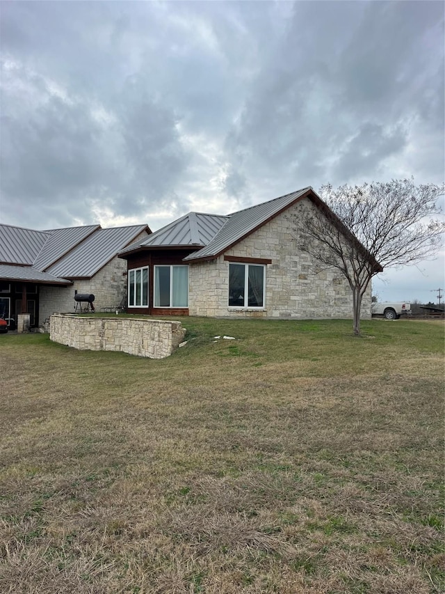 rear view of property featuring a lawn