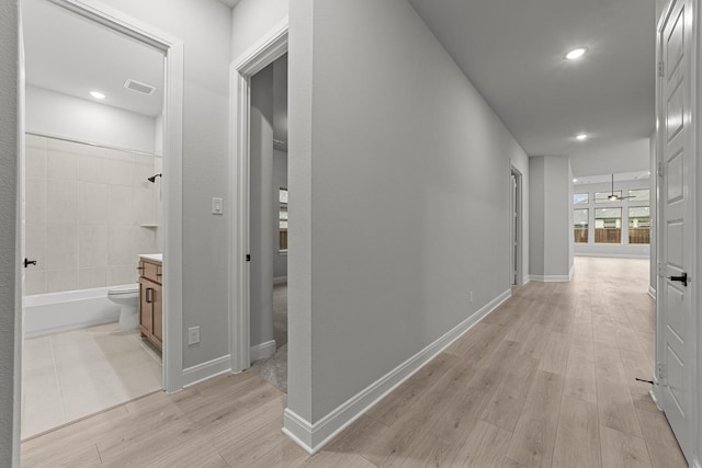 hall with light hardwood / wood-style floors