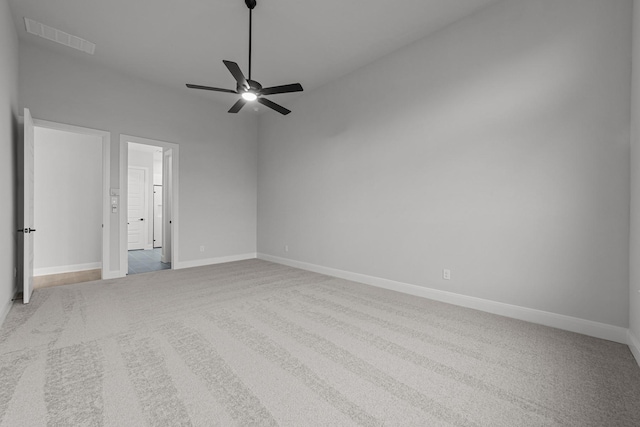 carpeted spare room with ceiling fan