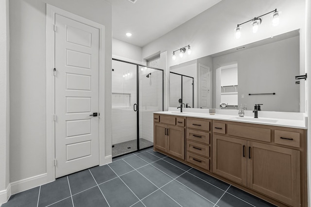 bathroom featuring a shower with door, vanity, and tile patterned floors