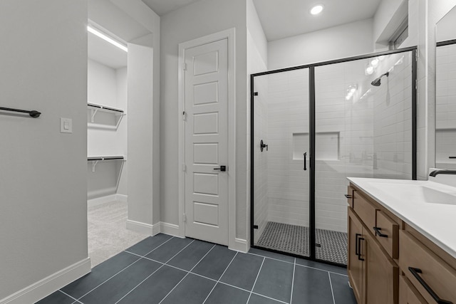 bathroom featuring vanity, an enclosed shower, and tile patterned flooring