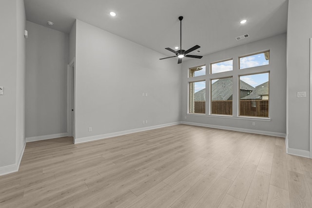 spare room with ceiling fan and light hardwood / wood-style flooring