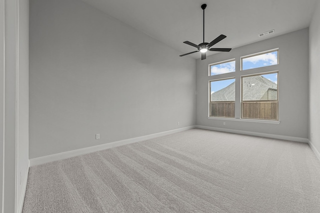 carpeted spare room with ceiling fan