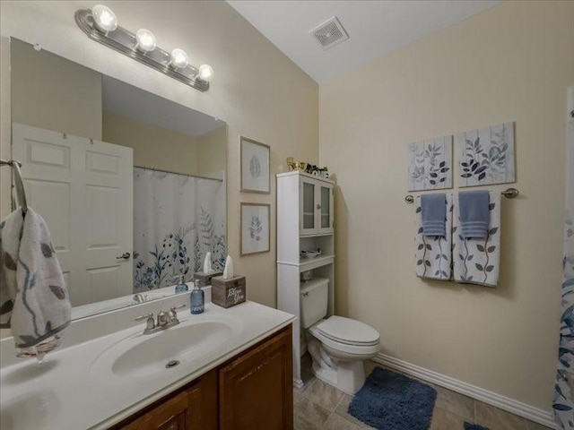 bathroom with vanity, tile patterned floors, and toilet