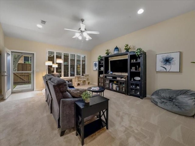 carpeted living room featuring lofted ceiling and ceiling fan