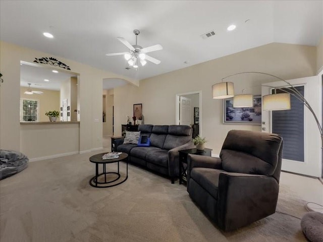 carpeted living room featuring vaulted ceiling and ceiling fan