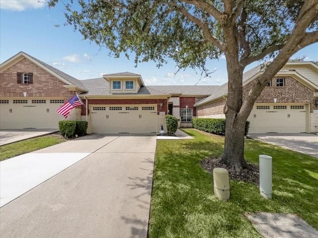 view of front of property with a garage, driveway, brick siding, and a front yard