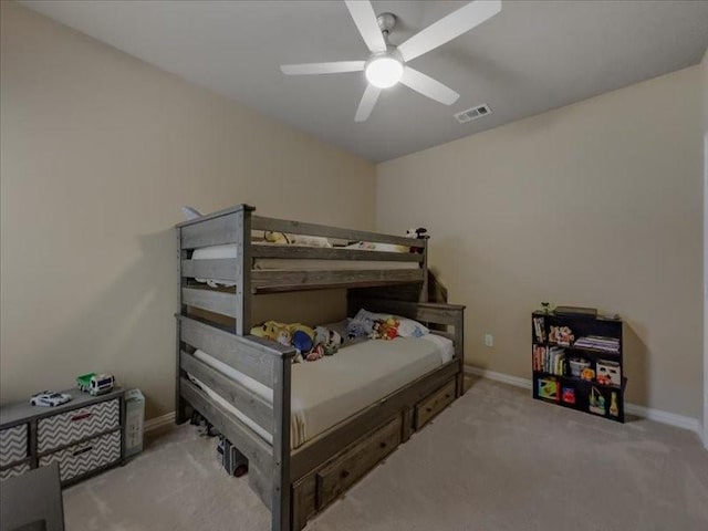 bedroom featuring ceiling fan and light carpet