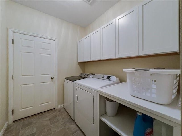 laundry room with independent washer and dryer and cabinets