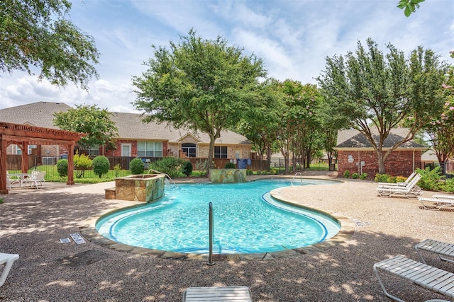 view of swimming pool featuring a patio, pool water feature, and a pergola