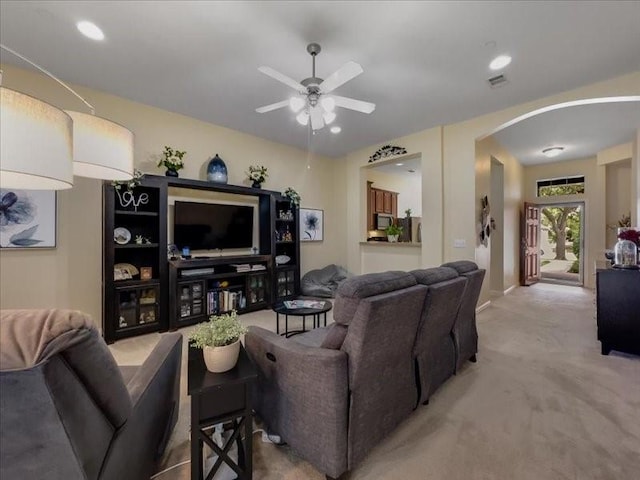 living room with ceiling fan and carpet