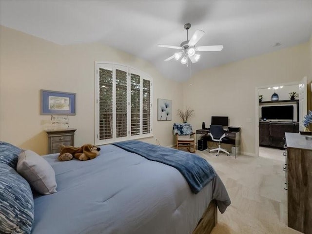 bedroom with vaulted ceiling, light colored carpet, and ceiling fan