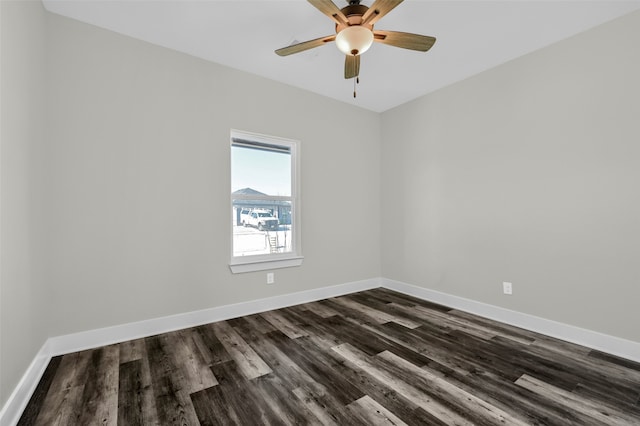 spare room with ceiling fan and dark hardwood / wood-style flooring