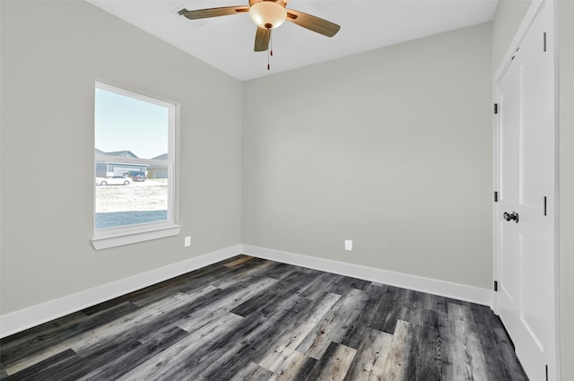 unfurnished room with ceiling fan and dark hardwood / wood-style flooring