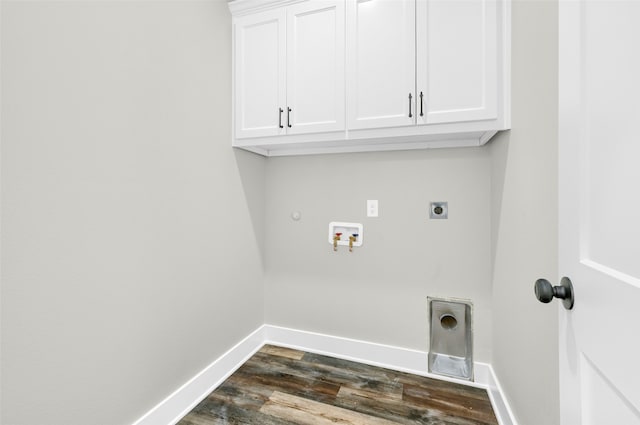 laundry room featuring gas dryer hookup, dark wood-type flooring, electric dryer hookup, hookup for a washing machine, and cabinets