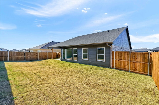 rear view of property with a yard