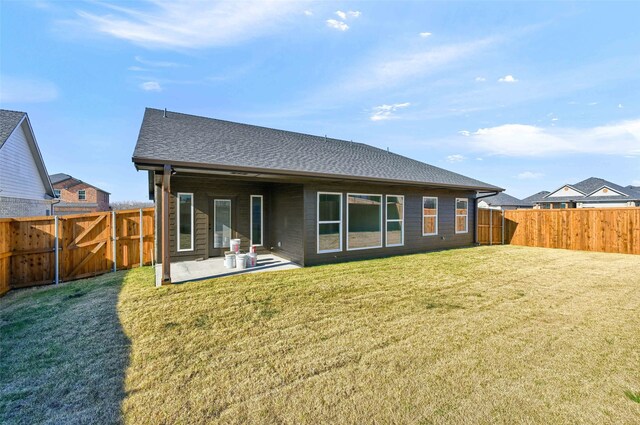 back of house with a yard and a patio area