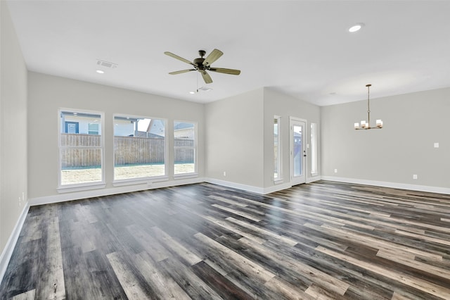 unfurnished living room featuring ceiling fan with notable chandelier and dark hardwood / wood-style flooring