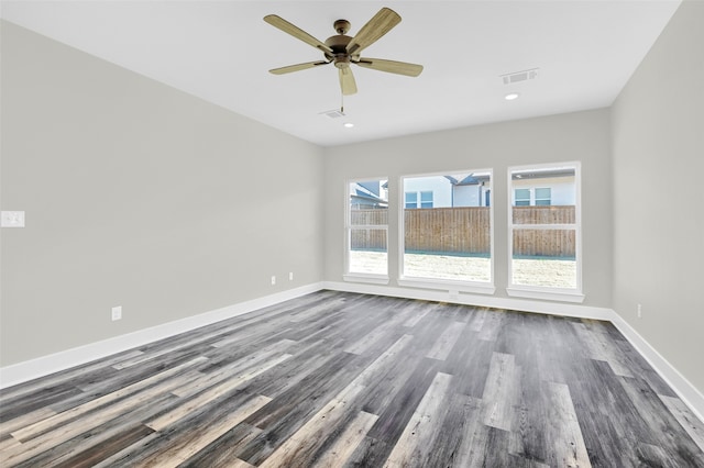 empty room featuring ceiling fan and dark hardwood / wood-style flooring