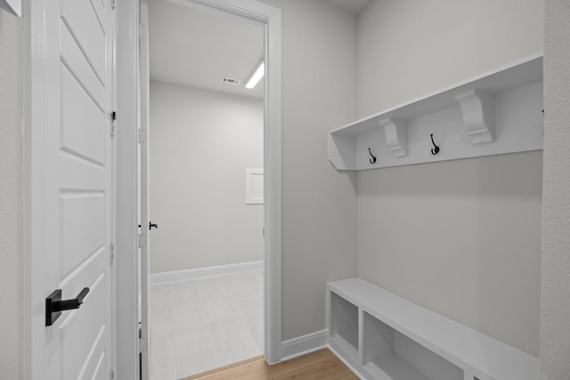 mudroom with light wood finished floors, visible vents, and baseboards