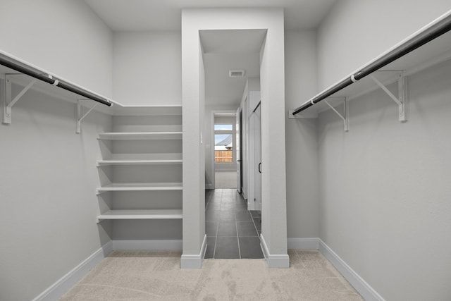 spacious closet featuring carpet flooring and visible vents