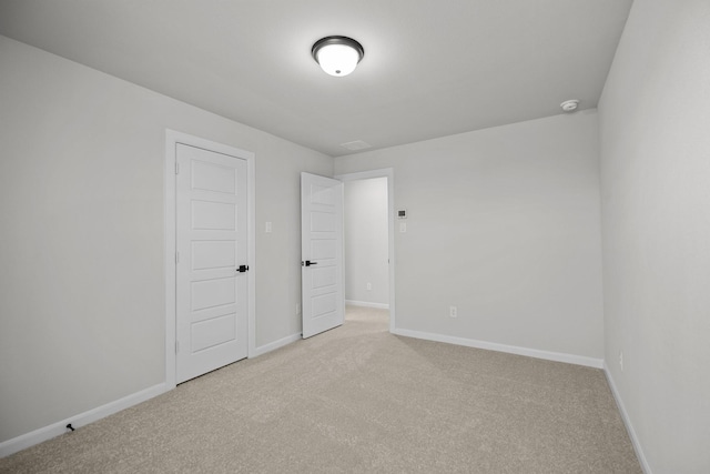 unfurnished bedroom featuring baseboards and carpet flooring