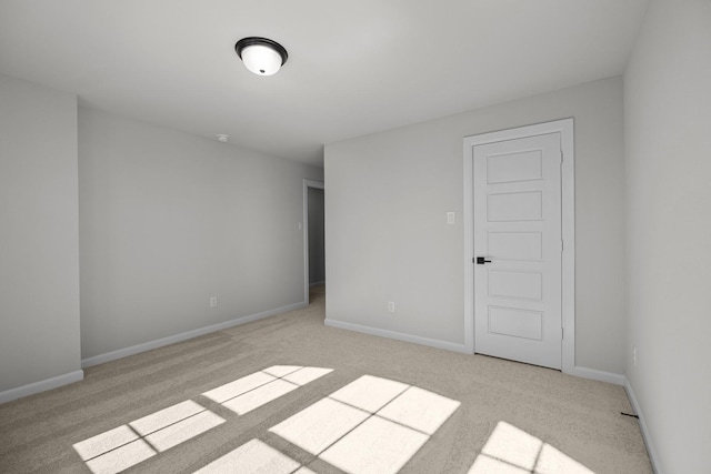 empty room featuring carpet floors and baseboards